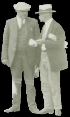 Two men standing in suits