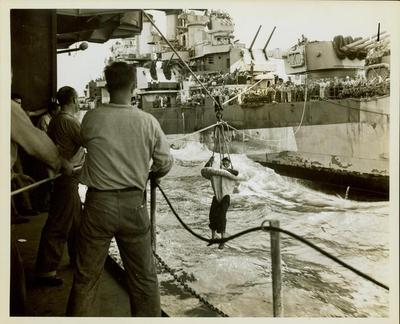 Photograph, A surviving sailor from the U.S.S. Houston being highlined from ship to ship