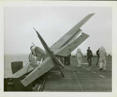 Photograph, Salvaging an FM2 aircraft aboard the U.S.S. Rudyerd Bay