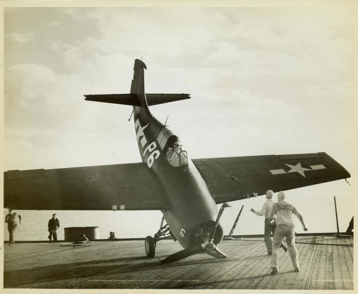 Photograph, FM1 aircraft damaged in barrier crash aboard U.S.S. Casablanca, Pilot Ensign Robert K. Lohman