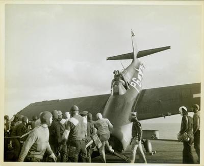 Photograph, FM1 aircraft damaged in barrier crash aboard U.S.S. Casablanca, Ensign Robert K. Lohman, pilot