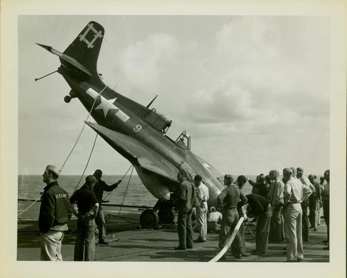 Photograph, Crashed FM2 aircraft aboard carrier in the Pacific during WWII