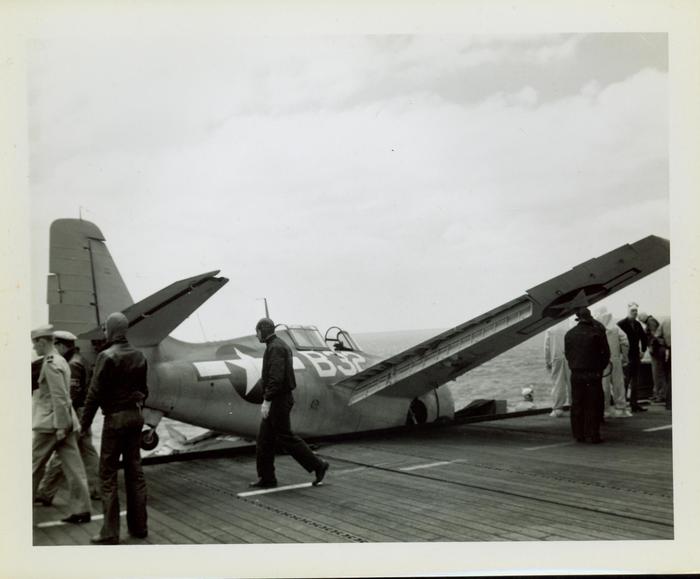 Photograph, Crashed FM2 aircraft looking across deck of U.S.S. Rudyerd Bay (CVE-81)