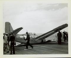 Photograph, Crashed FM2 aircraft looking across deck of U.S.S. Rudyerd Bay (CVE-81)