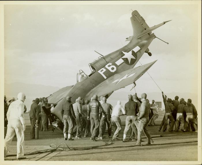 Photograph, FM1 Damaged in Barrier crash aboard U.S.S. Casablanca, Ens. Robert K. Lohman, pilot