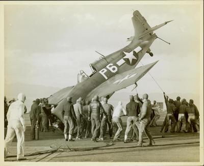 Photograph, FM1 Damaged in Barrier crash aboard U.S.S. Casablanca, Ens. Robert K. Lohman, pilot