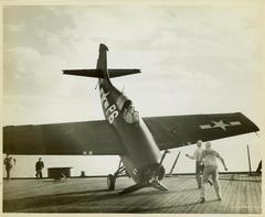 Photograph, FM1 aircraft damaged in barrier crash aboard U.S.S. Casablanca, Pilot Ensign Robert K. Lohman