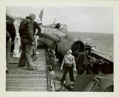 Photograph, Crashed FM2 On the port side (looking aft) of catwalk aboard U.S.S. Rudyerd Bay (CVE #81 -109)