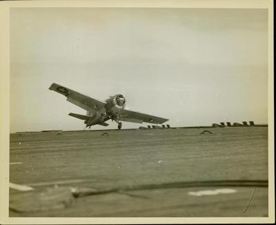 Photograph, F4F plane landing, Hook caught on rail, U.S.S. Rudyerd Bay
