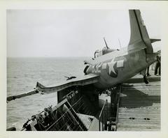 Photograph, Crashed FM2 aircraft aboard U.S.S. Rudyerd Bay, port side catwalk looking forward