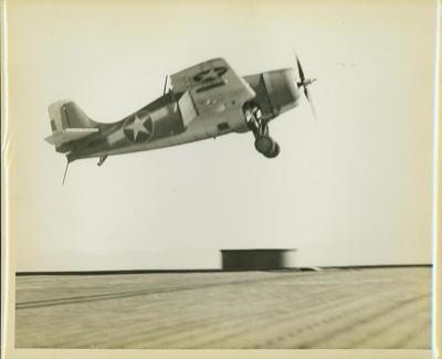 Photograph, F4F plane over Forward Stack avoiding crash, U.S.S. Rudyerd Bay