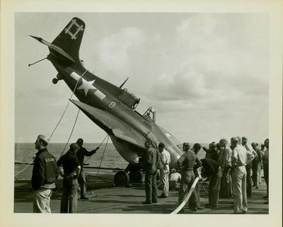 Photograph, Crashed FM2 aircraft aboard carrier in the Pacific during WWII