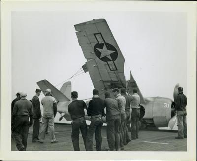 Photograph, Salvaging a crashed FM2 aircraft after a crash aboard the U.S.S. Rudyerd Bay