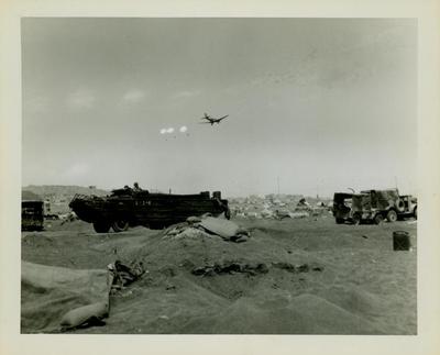 Photograph, Supply plane parachuting supplies over the beach at Iwo Jima