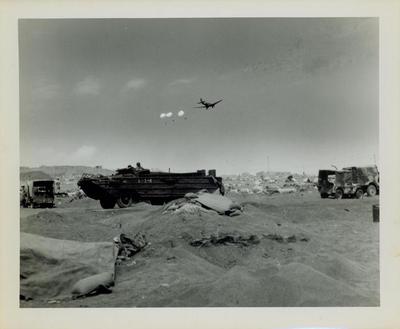 Photograph, Supply plane parachuting supplies over the beach at Iwo Jima