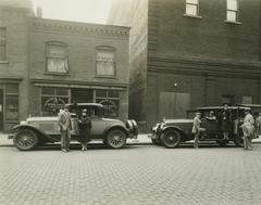 Photograph, People Standing Around Two Parked Cars