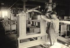 Photograph, Man Adjusts Furniture Clamp on Cabinet